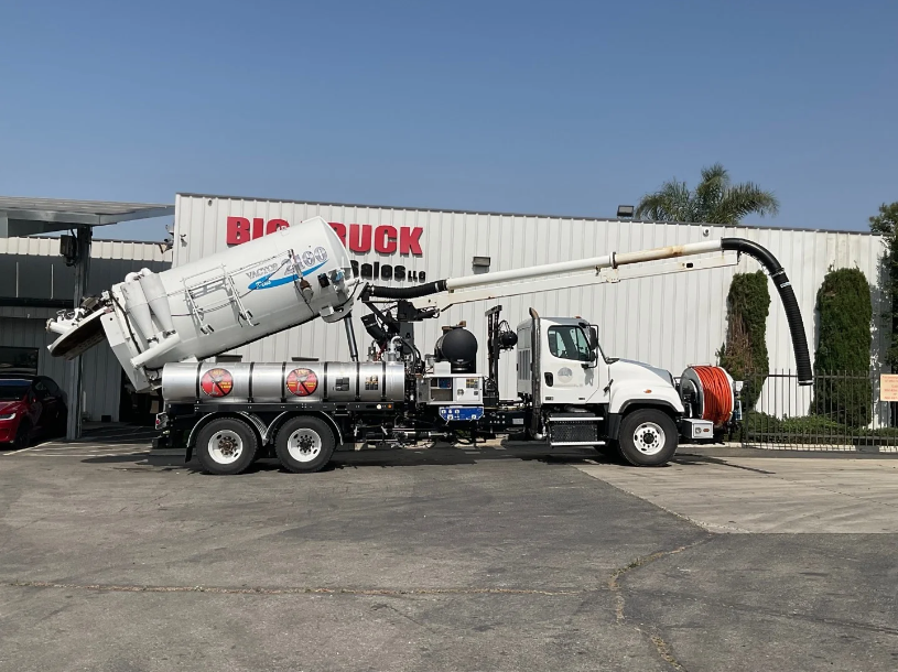 The vacuum truck is parked on the street